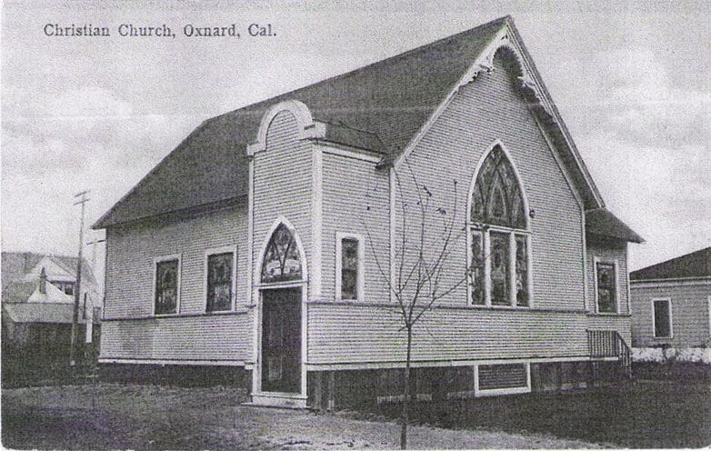Black and white photo of the Christian church in Heritage Square, Oxnard, California, featuring a prominent arched window and a gabled roof.