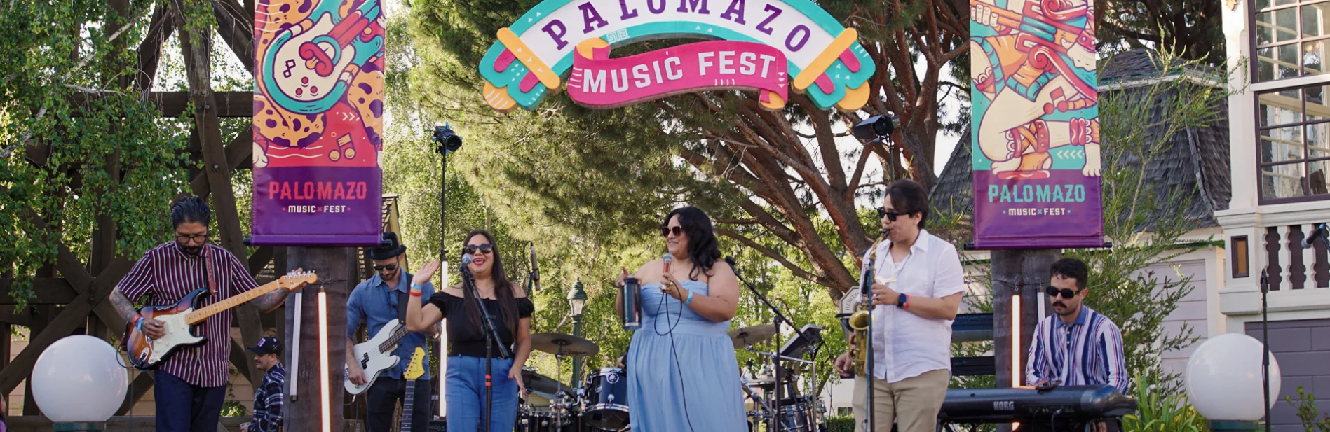 Heritage Square Oxnard music festival with live band and colorful banners.